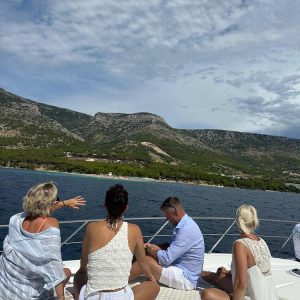 Guests relaxing on the deck of a luxury charter yacht.