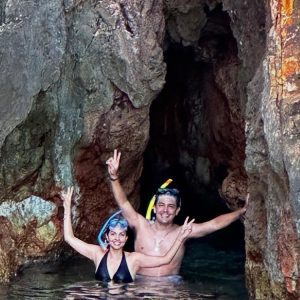 Couple snorkeling in a sea cave on the Adriatic coast.